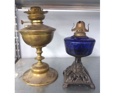 A VICTORIAN OIL TABLE LAMP WITH CAST IRON PIERCED SQUARE BASE, DARK BLUE POTTERY RESERVOIR AND BRASS OIL TABLE LAMP (2) 