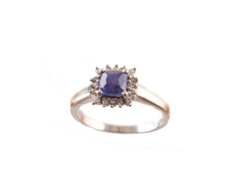 A tanzanite and diamond cluster ring, the square shape tanzanite within a brilliant cut diamond surround, stamped 750, total 