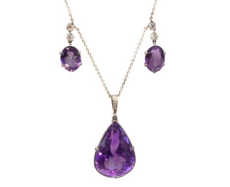 An amethyst and diamond pendant necklace retailed by Wartski, the pear shape amethyst pendant with a vari-cut diamond tapered
