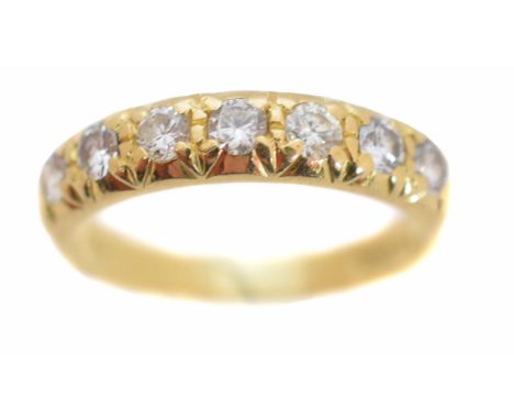 An 18ct gold diamond band ring, the brilliant cut diamond line inset to the polished band, hallmarks for London, 1975, estima