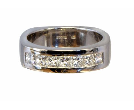 A platinum diamond band ring by David M Robinson, the square shape diamond line inset to the shaped band, hallmarks for Edinb