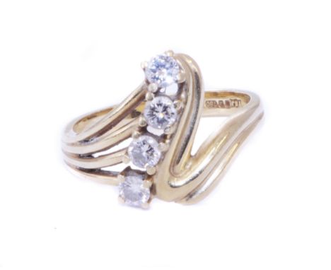 An 18ct gold diamond dress ring, designed as a brilliant cut diamond line with asymmetric shoulders, hallmarks for Sheffield,