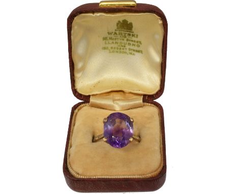 An amethyst dress ring retailed by Wartski, the oval shape amethyst in a yellow metal mount, ring size N. Accompanied by box 