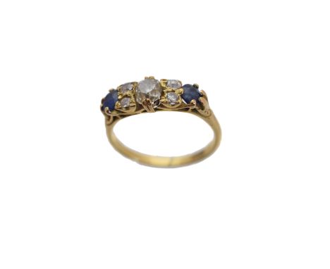 A sapphire and diamond dress ring, designed as an old cut diamond and circular shape sapphire line with vari cut diamond duo 