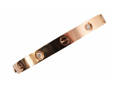 A Cartier diamond LOVE bangle, designed as a series of screw head motifs and brilliant cut diamond collets, with screw fittin