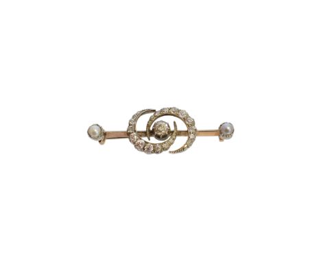 An early 20th Century diamond and split pearl brooch, the old cut diamond within an old and rose cut diamond double crescent 