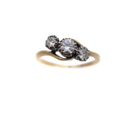 A diamond three stone ring, the brilliant cut diamond line with crossover shoulders, estimated total diamond weight 0.60ct, e