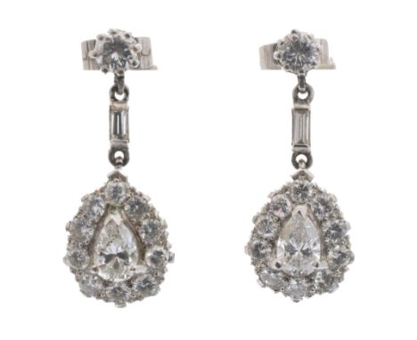 A pair of diamond drop earrings, each designed as a pear shape and brilliant cut diamond cluster drop, suspended from a bague