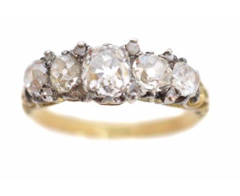 A late Victorian diamond five stone ring, the old cut diamond line with rose cut diamond spacers and scrolling shoulders, sta