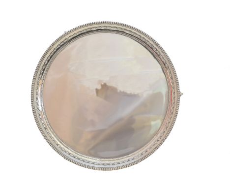 A 1930s silver salver, of circular outline with gadrooned surround raised on three ball and claw feet, hallmarks for James Di