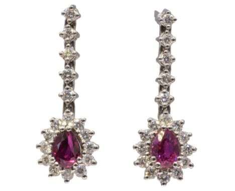 A pair of ruby and diamond earrings, each designed as a pear shape ruby and brilliant cut diamond cluster suspended from a si