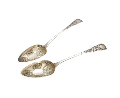 Two 19th Century silver berry spoons, of old English pattern, with embossed floral bowls and foliate detail stems, hallmarks 