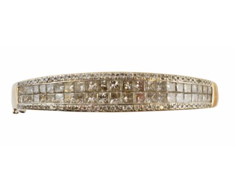 An 18ct gold diamond hinged bangle, the graduated square shape diamond double line with brilliant cut diamond sides and plain