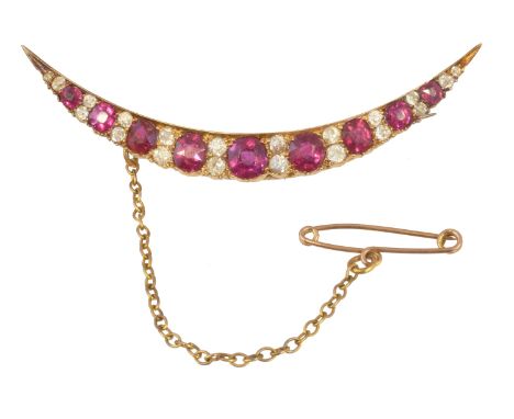 A late Victorian ruby and diamond crescent brooch retailed by Wartski, of typical form, the cushion shape ruby graduated line
