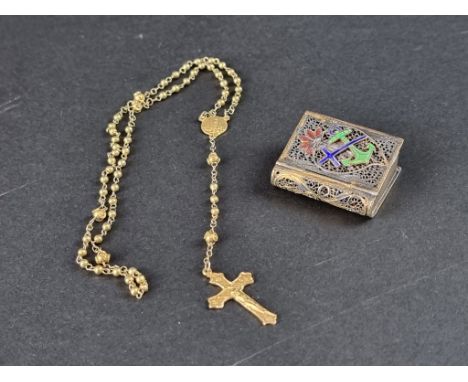 A gilt metal filigree and enamel novelty book vesta case, containing a plated crucifix and chain. 