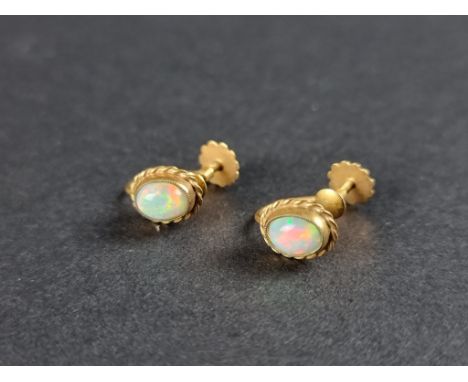 A pair of yellow metal and opal screw back earrings,&nbsp;stamped 9ct. 