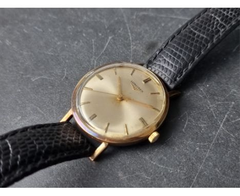 A vintage Longines gold plated manual wind wristwatch, 33mm, on replacement black leather strap. 