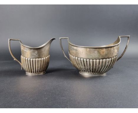 A Victorian silver twin handled sugar bowl and matching cream jug,&nbsp;by&nbsp;William Hutton &amp; Sons, London 1890, 325g.