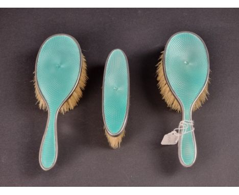 A child's silver and guilloche enamel three piece brush set, by&nbsp;William Devenport, Birmingham 1928. 