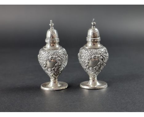 A pair of Victorian silver pepperettes, by&nbsp;Samuel M Levi, Birmingham 1899, 9.5cm high, 71g. 