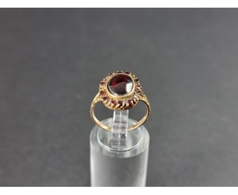 A yellow metal garnet cluster ring, stamped 9ct, size M 1/2. 