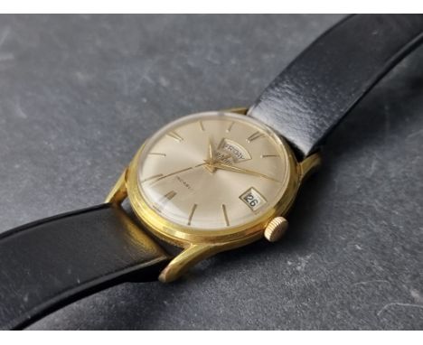 A 1960s Gradus gold plated day date manual wind wristwatch, 33mm, on black leather strap. 