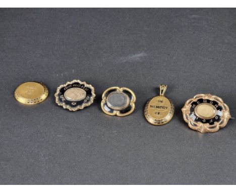 Three 19th century yellow metal and enamel mourning brooches, largest approximately 45mm; together with a similar later yello