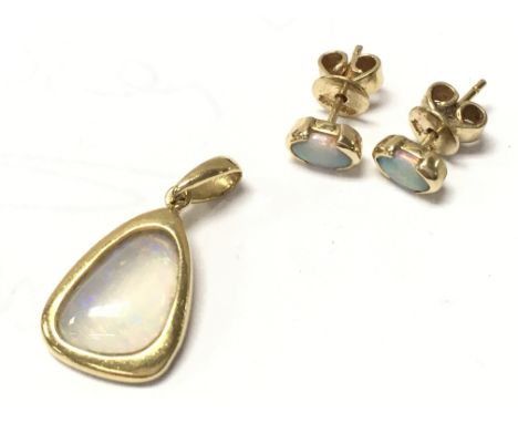An 18ct Opal pendant and a pair of 18ct stud earrings. 4.1g total weight. Postage category A