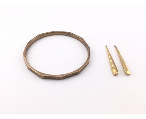 A 9ct gold bangle and a pair of earrings. Bangle is 8cm diameter. Total weight 25.20g Postage B