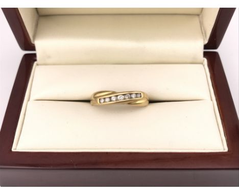 An 18ct yellow gold diamond set crossover style ring. Approx weight 3.60 grams, approx size M.