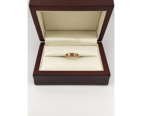 An 18ct ruby and diamond set ring. Approx weight 2.65 grams, approx size K.