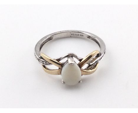A silver and 9ct gold ring with a central opal. Size L and 1.9g Postage A