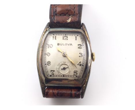 A vintage gents Bulova wrist watch on brown leather strap. Winds and runs. Postage B