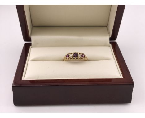 An 18ct gold ring set with Ruby and diamonds. Approx size P, approx weight 2.70 grams.