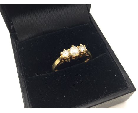 An 18ct gold three stone diamond ring. Approx weight 3.34 grams, size M.