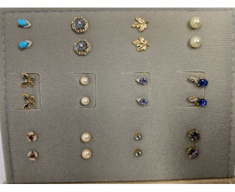 A small stud earring book, including a collection of silver and gold stud earrings.