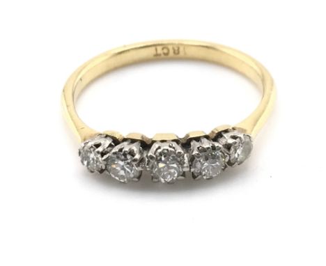 A 5 stone graduated 18ct gold ring. Size R and 2.68gPostage A
