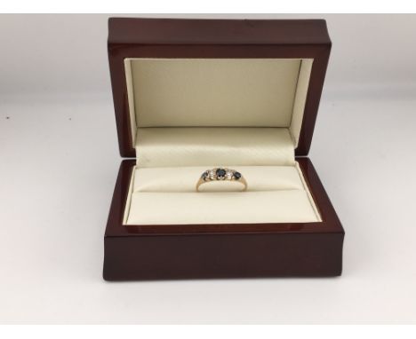 A yellow metal sapphire and diamond set ring (tested 18ct not hallmarked). Approx weight 2.09 grams, Approx size L.