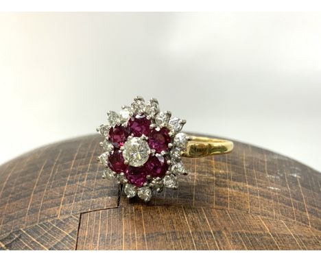 An 18ct ruby and diamond cluster ring, Size R, 4.74g. (A)