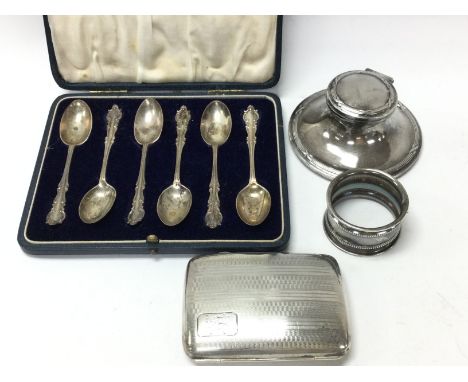 A collection of hallmarked silver items including a cased set of spoons, a cigarette case, napkin ring and an inkwell. Postag