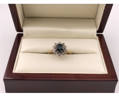 An 18ct diamond and sapphire cluster ring. Approx weight 4.07 grams, approx size N.