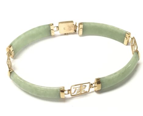 A jade and 9ct gold bracelet. Postage category A