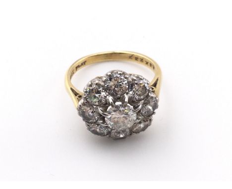 An 18k gold and platinum diamond cluster ring. Size J and 4.25g. Centre stone is approx 0.50ct Postage A