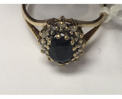 A 9 ct gold ring with sapphire and diamond chip inset size K .