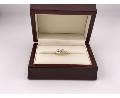 An 18ct three stone diamond ring. Approx weight 3.1 grams, approx size I 1/2.