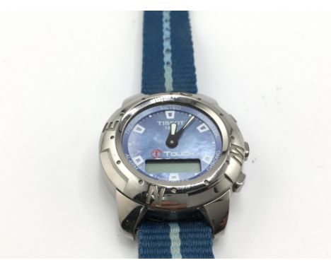 A Tissot Touch wrist watch with a mother of pearl dial and blue canvas strap and titanium case. Needs new battery. 42mm case.