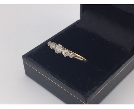 An 18ct five stone diamond set ring. Approx 2.2 grams, size P.