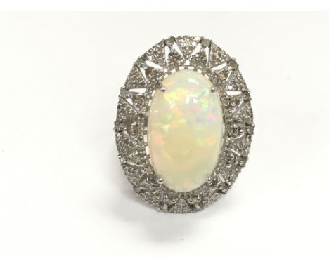 Ornate silver dress ring set with large oval cabochon opal and diamonds. Opal 9.67ct and diamonds 1.47ct appropriate. Size Q 