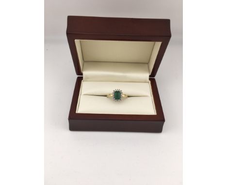 An 18ct gold diamond and emerald set ring. Approx weight 4.2grams, Approx size M 1/2.