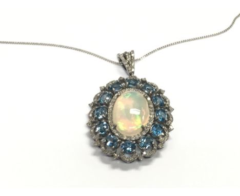 Large oval cluster pendant in silver set with oval cabochon opal surrounded by diamonds and oval london blue topaz on silver 